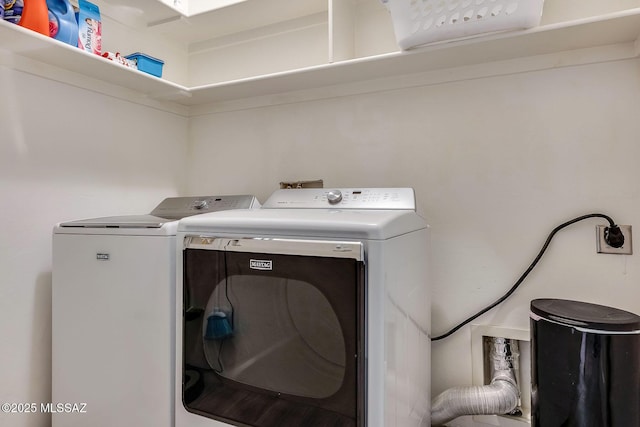 laundry room featuring separate washer and dryer and laundry area