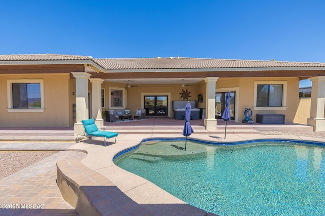 pool with a patio, ceiling fan, and french doors