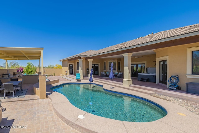 outdoor pool with french doors, a ceiling fan, outdoor dining space, and a patio area