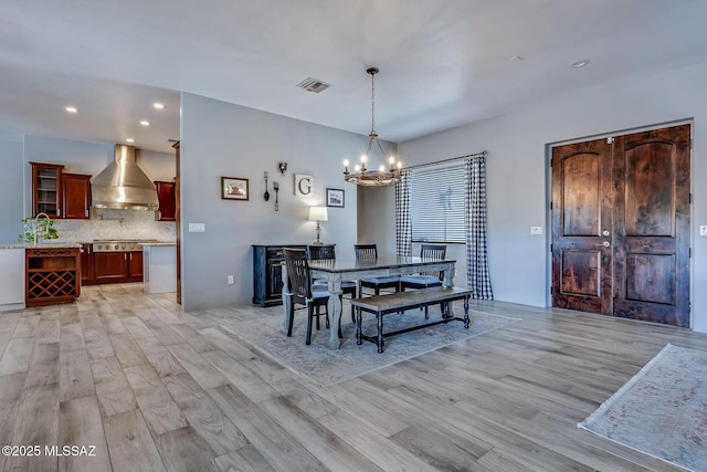 dining area featuring visible vents, recessed lighting, light wood finished floors, and a chandelier