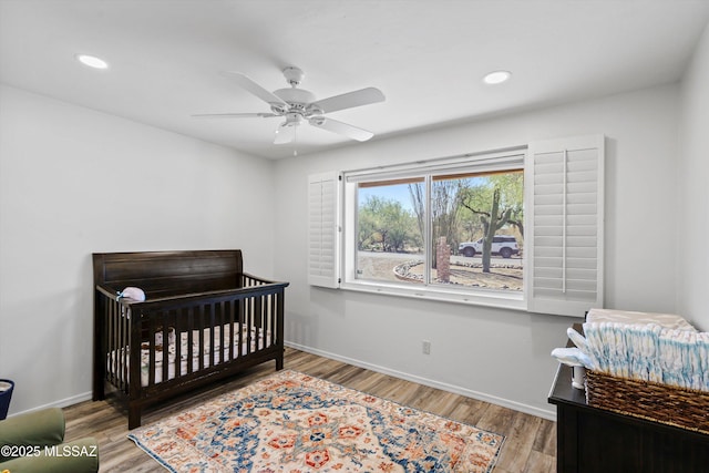 1932 W Harran Cir, Tucson, AZ 85704 - bedroom featuring baseboards, recessed lighting, wood finished floors, a nursery area, and ceiling fan