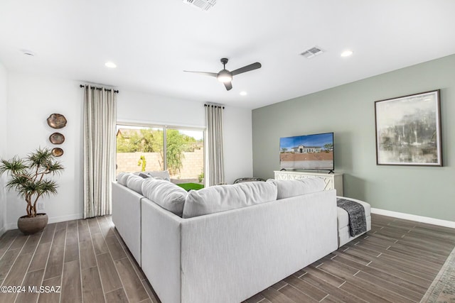 living room with visible vents, baseboards, a ceiling fan, and wood finish floors