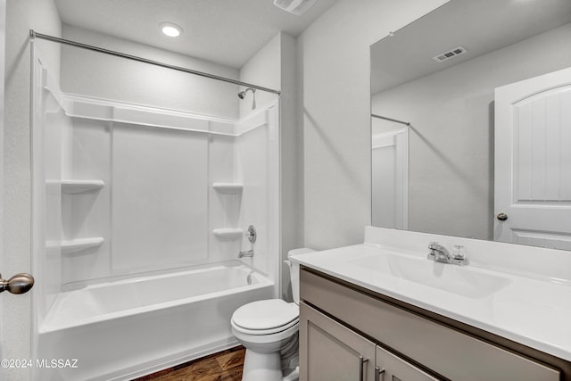 bathroom featuring vanity, toilet, visible vents, shower / bathing tub combination, and wood finished floors