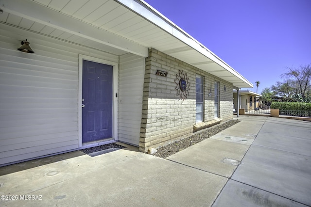 7217 E Fayette St, Tucson, AZ 85730 - view of exterior entry featuring brick siding