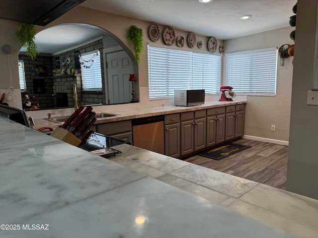 7217 E Fayette St, Tucson, AZ 85730 - kitchen with stainless steel appliances, wood finished floors, light countertops, recessed lighting, and baseboards