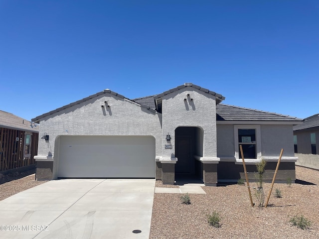 12088 E Patricia Ann Dr, Vail, AZ 85641 - view of front of house with a garage, driveway, stucco siding, and a tiled roof