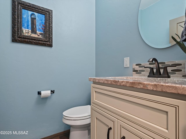 bathroom featuring toilet and vanity