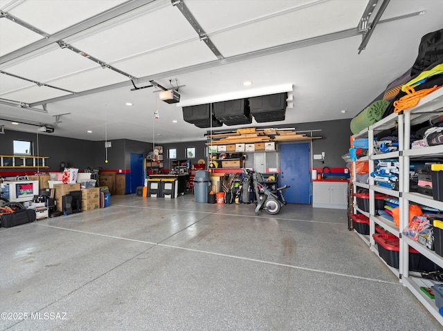 garage featuring a garage door opener and a workshop area