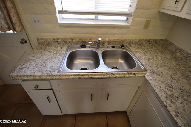 2665 N Leah Pl, Tucson, AZ 85705 - kitchen view of a sink, white cabinets, light countertops, and dishwashing machine