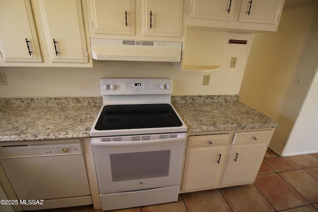 2665 N Leah Pl, Tucson, AZ 85705 - kitchen with white appliances, under cabinet range hood, light tile patterned flooring, and white cabinetry