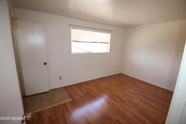 2665 N Leah Pl, Tucson, AZ 85705 - empty room with wood finished floors and baseboards