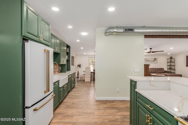 6821 N Cassim Pl, Tucson, AZ 85704 - kitchen featuring high end fridge, green cabinetry, recessed lighting, light wood finished floors, and a sink