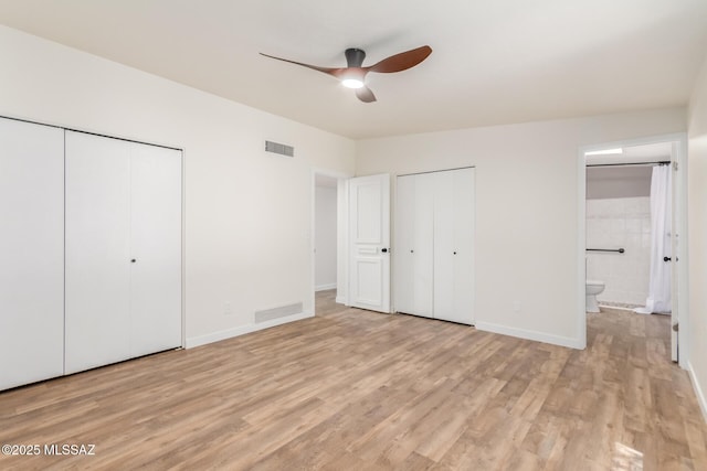 6821 N Cassim Pl, Tucson, AZ 85704 - unfurnished bedroom featuring multiple closets, light wood-type flooring, ensuite bathroom, and baseboards