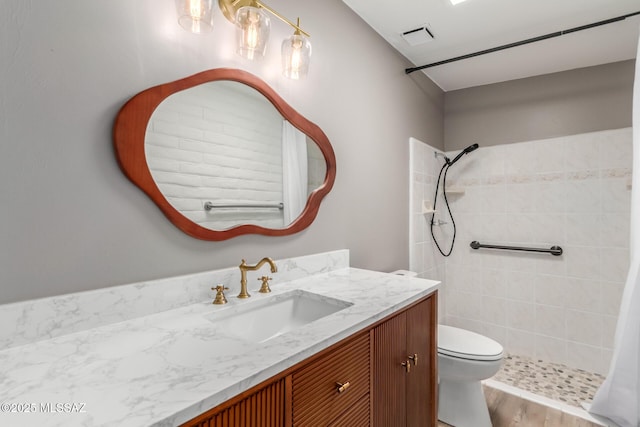 6821 N Cassim Pl, Tucson, AZ 85704 - full bath with vanity, tiled shower, toilet, and wood finished floors