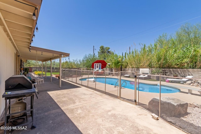 6821 N Cassim Pl, Tucson, AZ 85704 - view of swimming pool with a fenced backyard, a patio, and an outbuilding