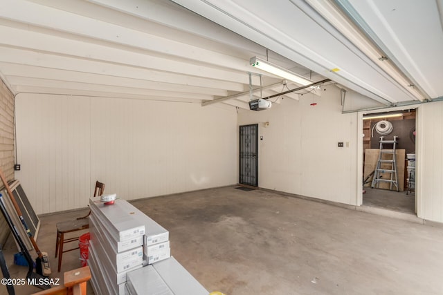 6821 N Cassim Pl, Tucson, AZ 85704 - garage featuring a garage door opener and wooden walls