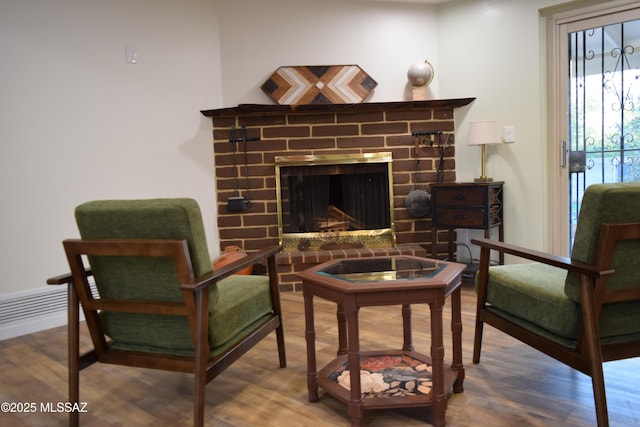 6821 N Cassim Pl, Tucson, AZ 85704 - living area featuring wood finished floors and a brick fireplace