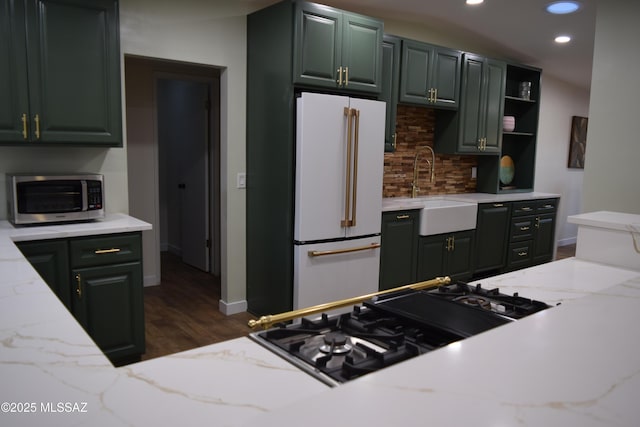 6821 N Cassim Pl, Tucson, AZ 85704 - kitchen featuring stainless steel microwave, freestanding refrigerator, backsplash, recessed lighting, and dark wood-type flooring