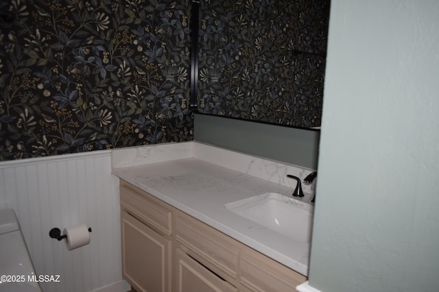 6821 N Cassim Pl, Tucson, AZ 85704 - bathroom with wallpapered walls, wainscoting, and vanity