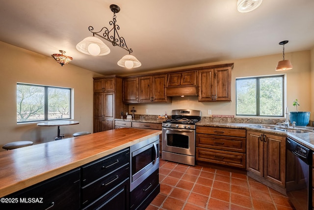 17300 S Camino Cartagena, Sahuarita, AZ 85629 - kitchen featuring a sink, butcher block counters, a wealth of natural light, and stainless steel appliances