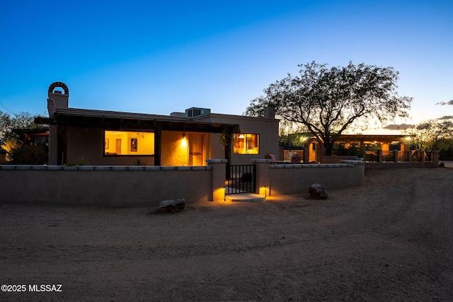 17300 S Camino Cartagena, Sahuarita, AZ 85629 - view of front facade featuring a gate, a fenced front yard, and stucco siding