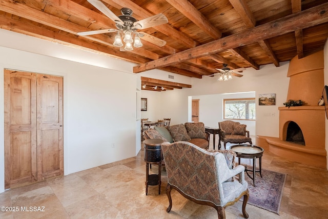 17300 S Camino Cartagena, Sahuarita, AZ 85629 - living area with a ceiling fan, wood ceiling, beam ceiling, and a large fireplace