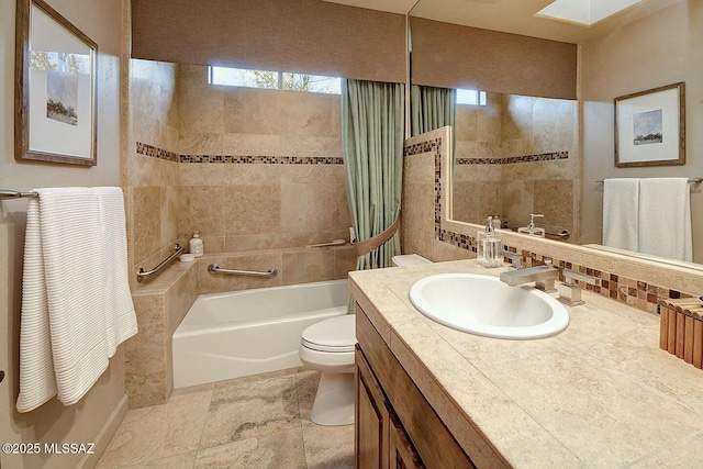 bathroom featuring shower / bathtub combination, vanity, and toilet