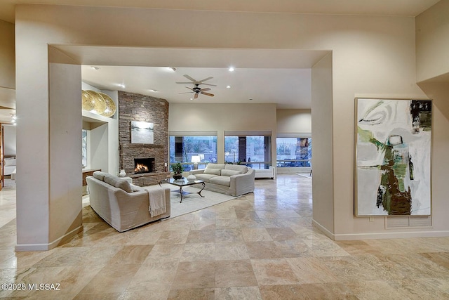 living room with recessed lighting, a stone fireplace, visible vents, baseboards, and ceiling fan