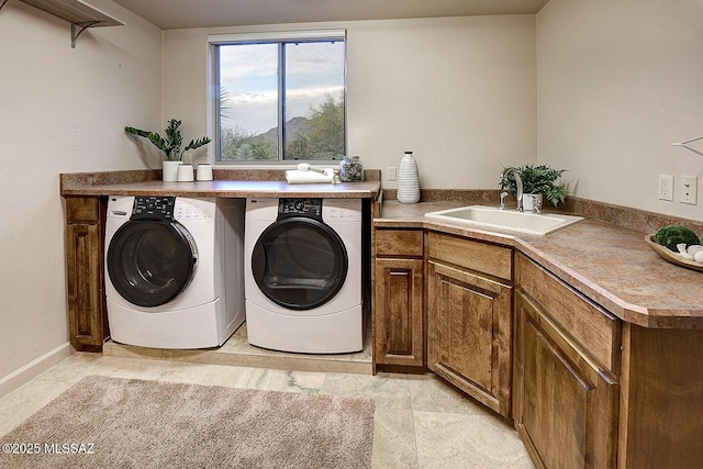 laundry area with independent washer and dryer, a sink, and laundry area