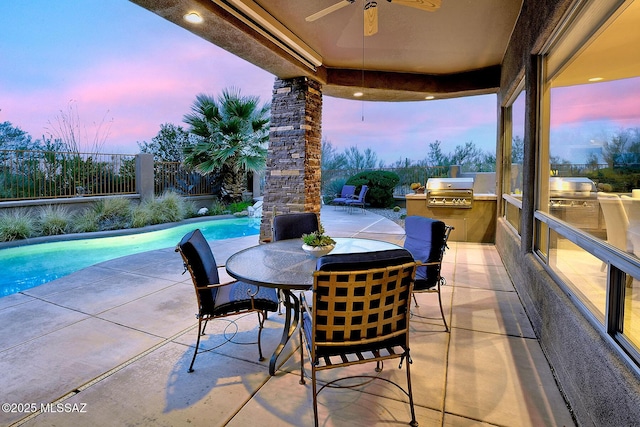 view of patio / terrace with exterior kitchen, a fenced backyard, ceiling fan, grilling area, and an outdoor pool