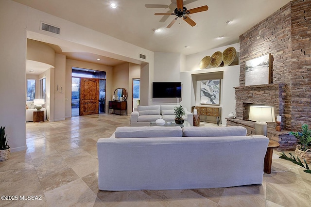 living area featuring baseboards, visible vents, recessed lighting, and ceiling fan