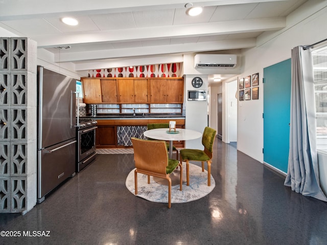 kitchen with beam ceiling, a wall unit AC, brown cabinets, a sink, and appliances with stainless steel finishes