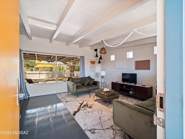 living area featuring finished concrete flooring and beam ceiling