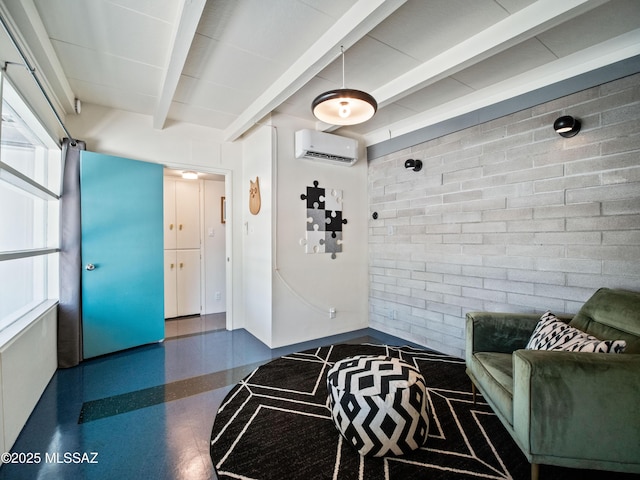 interior space featuring a wall mounted air conditioner, speckled floor, brick wall, and beamed ceiling