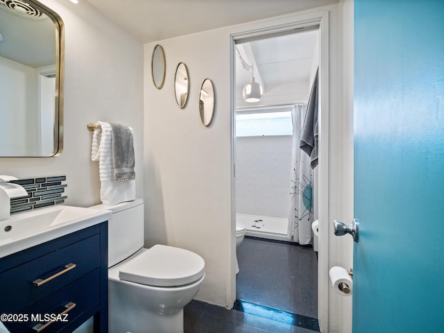 full bathroom with vanity, a shower stall, and toilet