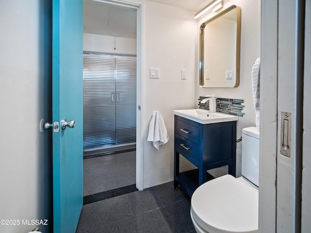 bathroom featuring toilet and vanity
