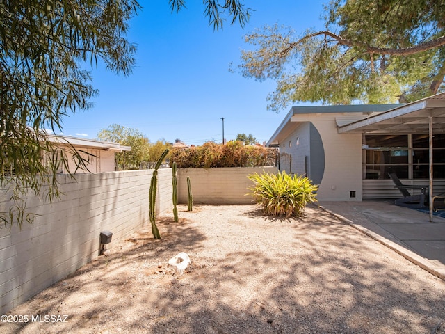 view of yard featuring fence and a patio