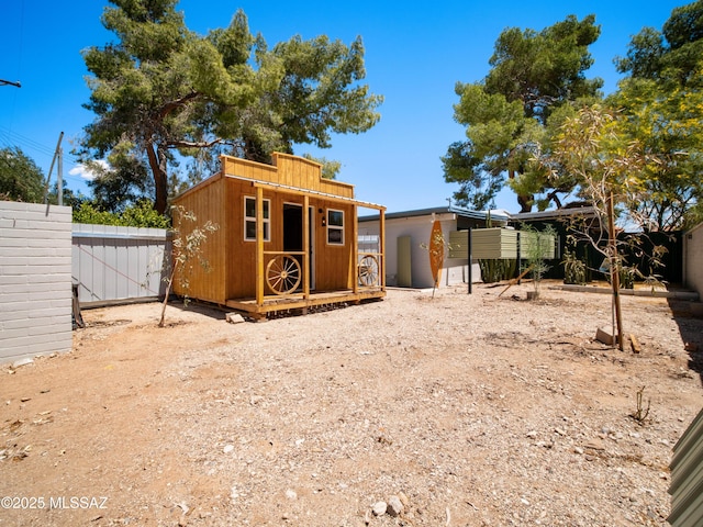 exterior space featuring fence and an outdoor structure