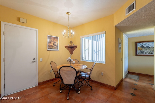 tiled dining room featuring visible vents, baseboards, and an inviting chandelier