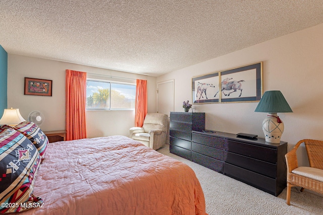 bedroom featuring carpet flooring and a textured ceiling