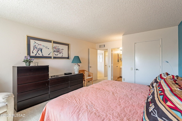 carpeted bedroom with a textured ceiling and visible vents