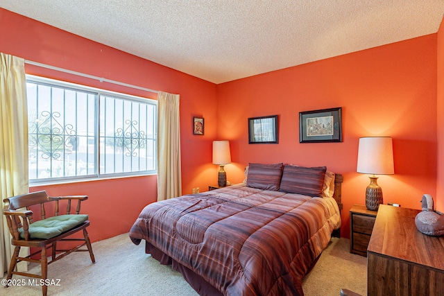 carpeted bedroom featuring a textured ceiling