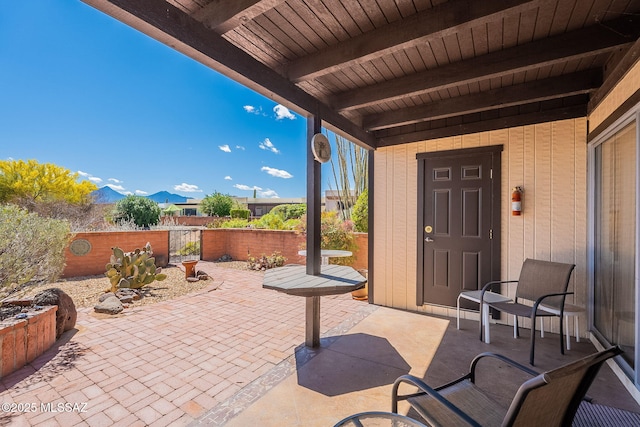 view of patio / terrace with a fenced backyard and a mountain view
