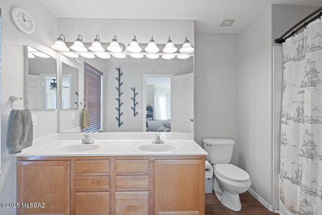 3969 W Pine Creek Way, Tucson, AZ 85745 - bathroom with ensuite bath, toilet, a sink, and double vanity
