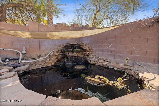 3969 W Pine Creek Way, Tucson, AZ 85745 - exterior details with a garden pond and a fenced backyard