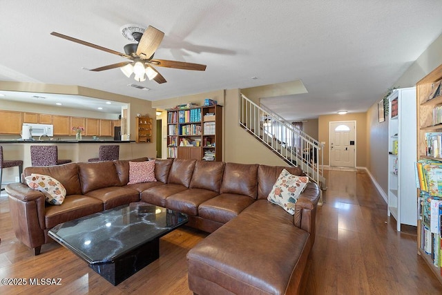 3969 W Pine Creek Way, Tucson, AZ 85745 - living room featuring visible vents, baseboards, a ceiling fan, wood finished floors, and stairway