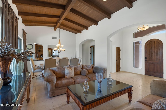 11028 N Pusch Ridge View Pl, Oro Valley, AZ 85737 - living area with wooden ceiling with exposed beams, arched walkways, a chandelier, light tile patterned floors, and high vaulted ceiling