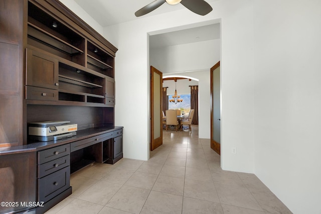 11028 N Pusch Ridge View Pl, Oro Valley, AZ 85737 - unfurnished office with light tile patterned flooring, a ceiling fan, arched walkways, and built in desk