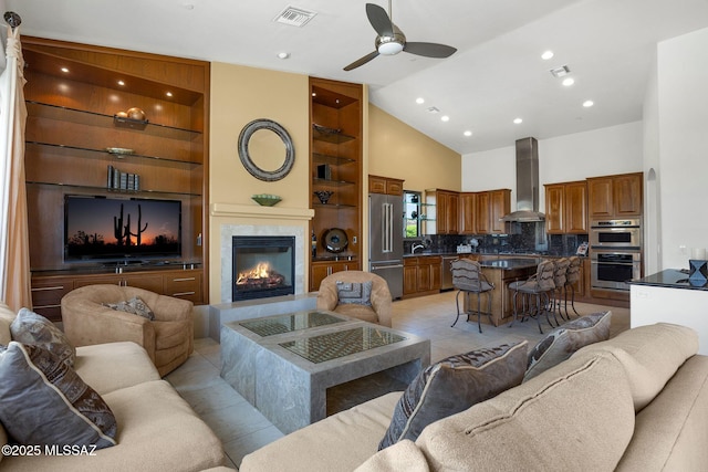 11028 N Pusch Ridge View Pl, Oro Valley, AZ 85737 - living area with ceiling fan, built in shelves, high vaulted ceiling, a fireplace, and light tile patterned floors