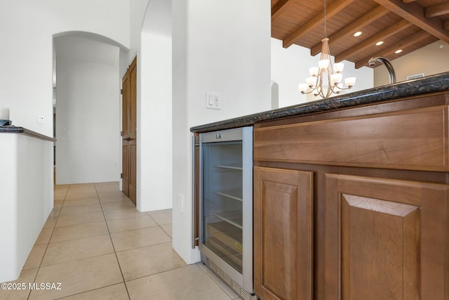 11028 N Pusch Ridge View Pl, Oro Valley, AZ 85737 - detailed view of beverage cooler, wood ceiling with exposed beams, arched walkways, and a chandelier